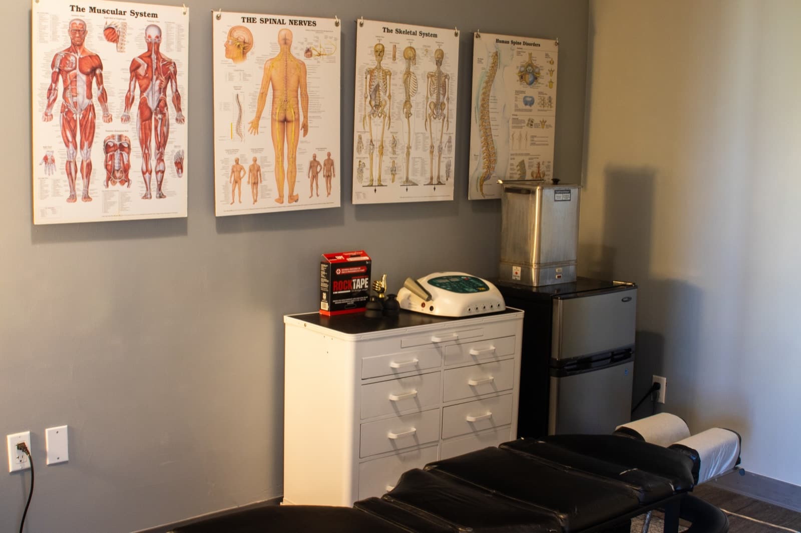 Treatment tables and rehab equipment inside the QiroFit sports chiropractic clinic in Los Angeles.