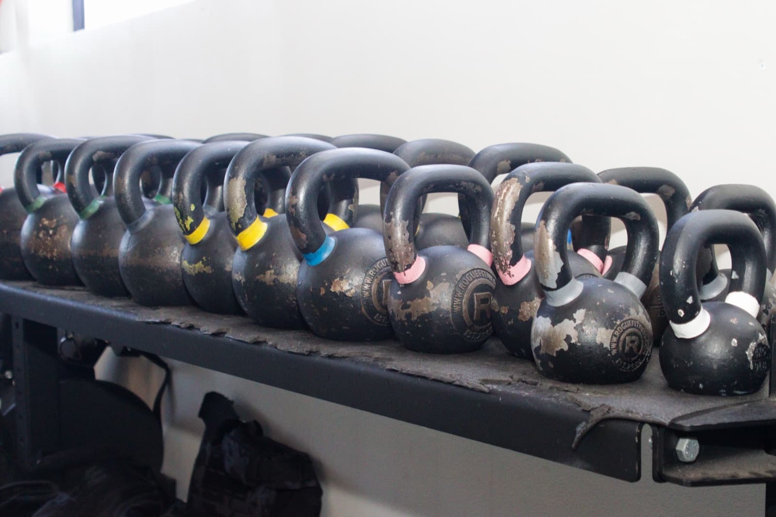 Kettlebells and training tools on the QiroFit rehab floor.